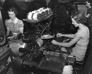 Two women working at cigar bunch making machines in a Tampa Cigar factory.