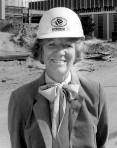 Portrait of Phyillis Marshall with a construction hard hat on her head.