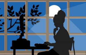 Silhouette of a woman at a computer late at night