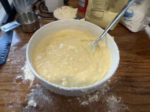 Wisconsin Crumb Cake fresh out of the oven in a glass baking dish, golden brown with a crumb topping.