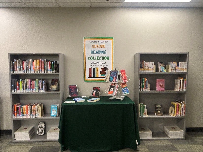 Two book cases with a table in the middle, each full of books.
