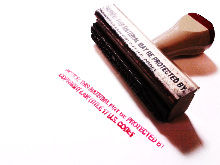 Copyright notice stamp lying on its side with stamped text showing