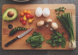 A knife and Food on a cutting board