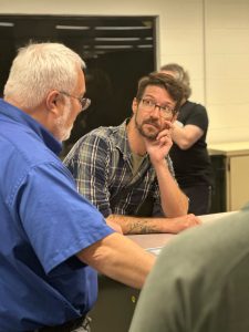 Chris Kiahtipes, Ph.D., Curator of the Florida Environment and Natural History (FLENH) initiative, looking at USF Libraries Dean Todd Chavez.