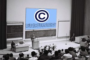 Photo of man at lectern in front of classroom