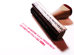 Copyright notice stamp lying on its side with stamped text showing