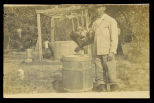 Lue Gim Gong and his pet rooster "March" in front of a well.